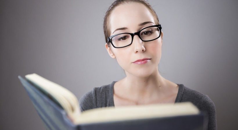 donna che legge un libro domandandosi come funziona il recupero anni scolastici